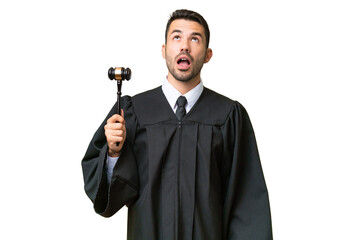 Judge caucasian man over isolated background looking up and with surprised expression