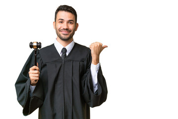 Judge caucasian man over isolated background pointing to the side to present a product