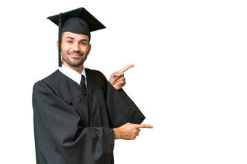 Young university graduate man over isolated background pointing finger to the side and presenting a...