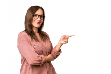 Middle-aged caucasian woman over isolated background pointing finger to the side
