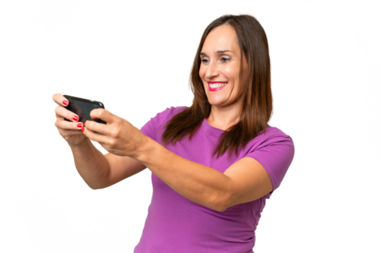 Middle-aged caucasian woman over isolated background playing with the mobile phone