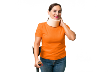Middle-aged caucasian woman wearing neck brace over isolated background laughing