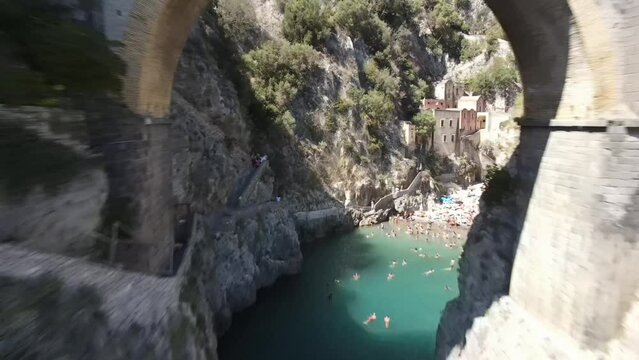 Aerial video of the stone arch bridge of Furora Fiord, Amalfi Coast, Italy