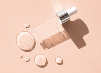 pipette drop of serum test on a beige background sun glare