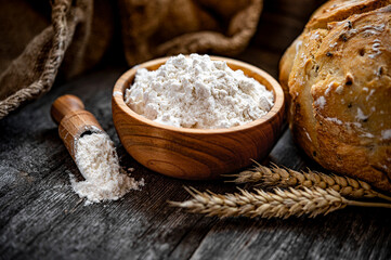 Wheat flour on an old wooden table