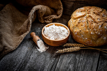 Wheat flour on an old wooden table