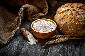 Wheat flour on an old wooden table