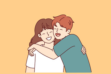 Positive little boy and girl hugging and laughing enjoying spending time together or summer vacation. Concept of happy childhood and friendship between classmates or little brother and sister 