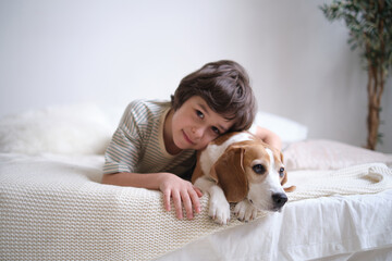 Child and Pet Mental Health. Pet-Child Bond. young boy with his beagle. positive impact of pets on...