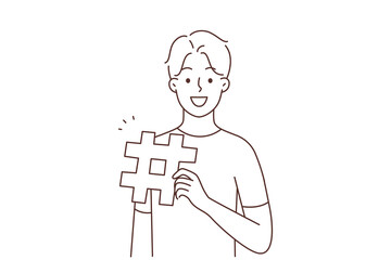 Smiling man with hashtag sign 