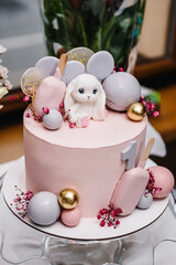 Birthday cake for 1 year. The cake is decorated with a rabbit figure and flowers decor for the...