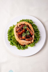 popular special wok fried sweet and sour pork ribs with deep fried yam ring on white wood table asian chinese banquet meat menu for restaurant 