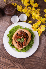 popular special wok fried sweet and sour pork ribs with deep fried yam ring on white wood table asian chinese banquet meat menu for restaurant 