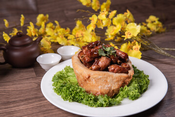 popular special wok fried sweet and sour pork ribs with deep fried yam ring on white wood table asian chinese banquet meat menu for restaurant 