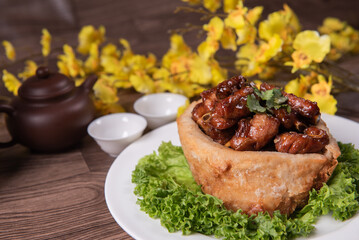 popular special wok fried sweet and sour pork ribs with deep fried yam ring on white wood table asian chinese banquet meat menu for restaurant 