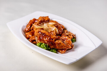 fresh wok fried sweet and sour pork chop chicken in Mongolian style on wood table background asian Chinese halal banquet meat menu for restaurant