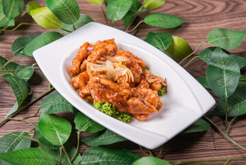 fresh wok fried sweet and sour pork chop chicken in Mongolian style on wood table background asian Chinese halal banquet meat menu for restaurant