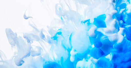 Fototapeta na wymiar Color drop of blue and white paint underwater abstract blur background