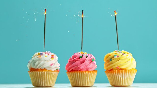 Birthday Cup Cakes With Burning Sparkles on Pastel Blue Background. Super Slow Motion, 1000 FPS.