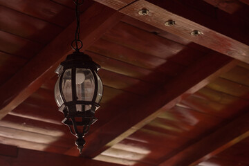 Stylized lantern on the background of a red ceiling