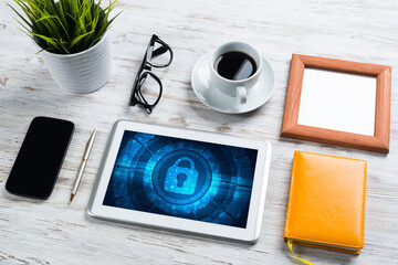 Web security and technology concept with tablet pc on wooden table