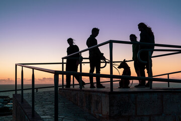 Fototapeta na wymiar silhouette of a a group of friends at sunset