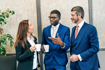 Multiracial businesspeople talking during coffee break
