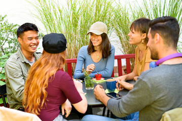Diverse friends enjoy breakfast in outdoor cafe