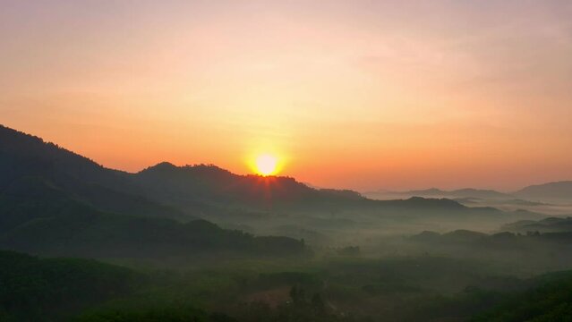 aerial view stunning sunrise above the mountain ridge. .Scene of colorful light trough in the dark valley with mist..Gradient color. Sky texture, amazing abstract nature background.