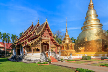 Chapel and golden pagoda at Wat Phra Singh Woramahawihan, famous travel destination in Chiang Mai,...
