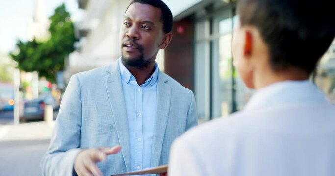 Sales, insurance and black businessman or salesman talking to a client explaining using a clipboard outdoors in a city or town. Advice, explain and male agent having a conversation in the street