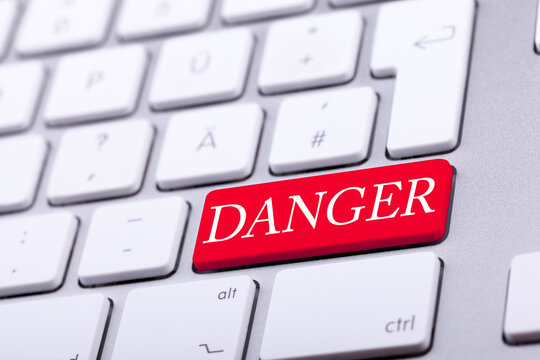 High end aluminium keyboard with DANGER word in red on it. Danger and alert