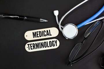 stethoscope and glasses with the words MEDICAL TERMINOLOGY. syringe, vial and pills. Medical Concept