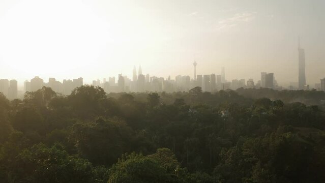 landscape view of kuala lumpur city center downtown district area with many skyscraper building highrise modern style towers with beautiful vanilla sundown sunrise