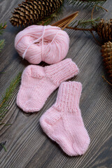 Fototapeta na wymiar Small and soft baby socks made of pink cotton yarn 