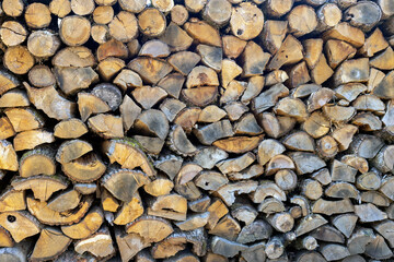 Wood texture. Chopped wood is ready for heating in the fireplace. Chopped firewood lies in a pile. woodpile close-up. Selective focus.