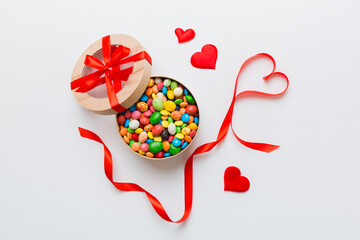 Valentine day composition: sweet candy, with gift boxes with bow and red felt hearts, photo template, background. Top View with copy space