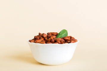 Fresh healthy peanuts in bowl on colored table background. Top view Healthy eating bertholletia concept. Super foods