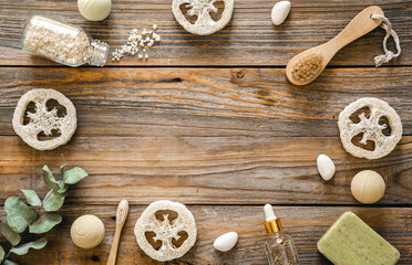 Spa composition with body care items on wooden background, top view.