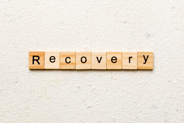 recovery word written on wood block. recovery text on table, concept