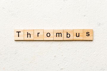 thrombus word written on wood block. thrombus text on table, concept
