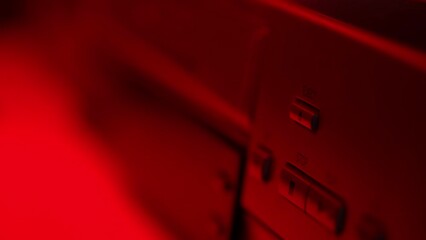 Close-up of a hand pressing the eject button on a VHS deck.