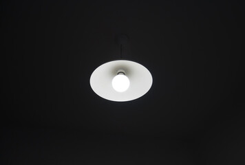 Black minimalist lamp in modern loft-style cafe or home. Cool interior design idea.