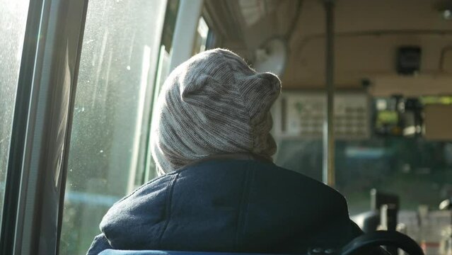 selective focusing view to a man sit on seat on the bus while moving up to mountain range hill with sunlight shine
