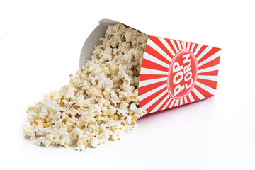 Popcorn in red and white striped cardboard bucket isolated on white background