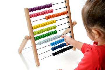 little child playing with abacus