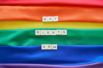 Gay rights now concept. Gay rights now spelled with craft letters over lgbt rainbow flag