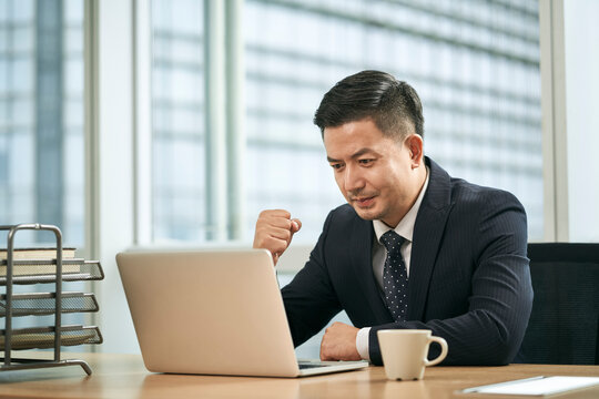 asian business man working in office using laptop computer