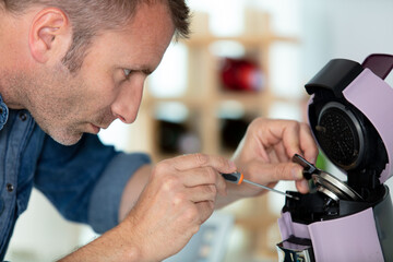 man repairing a coffee machine