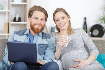 relaxed loving pregnant couple with coffee cups